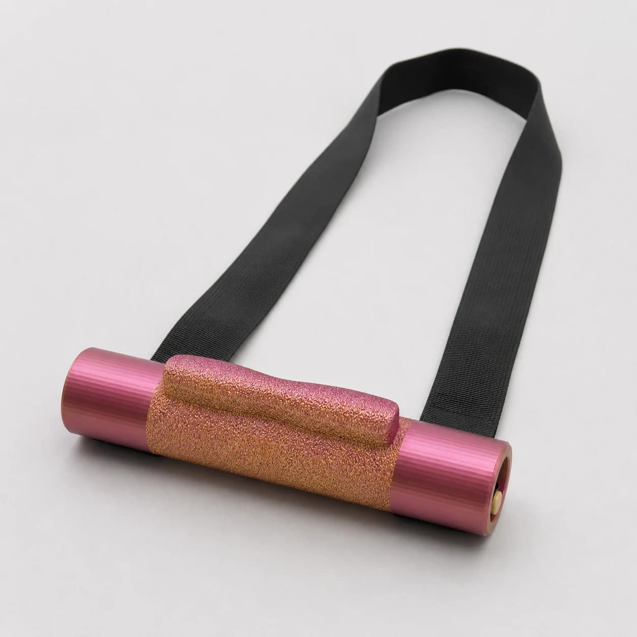 Finger Wrench training handle with textured grip roller and black strap, angled studio view